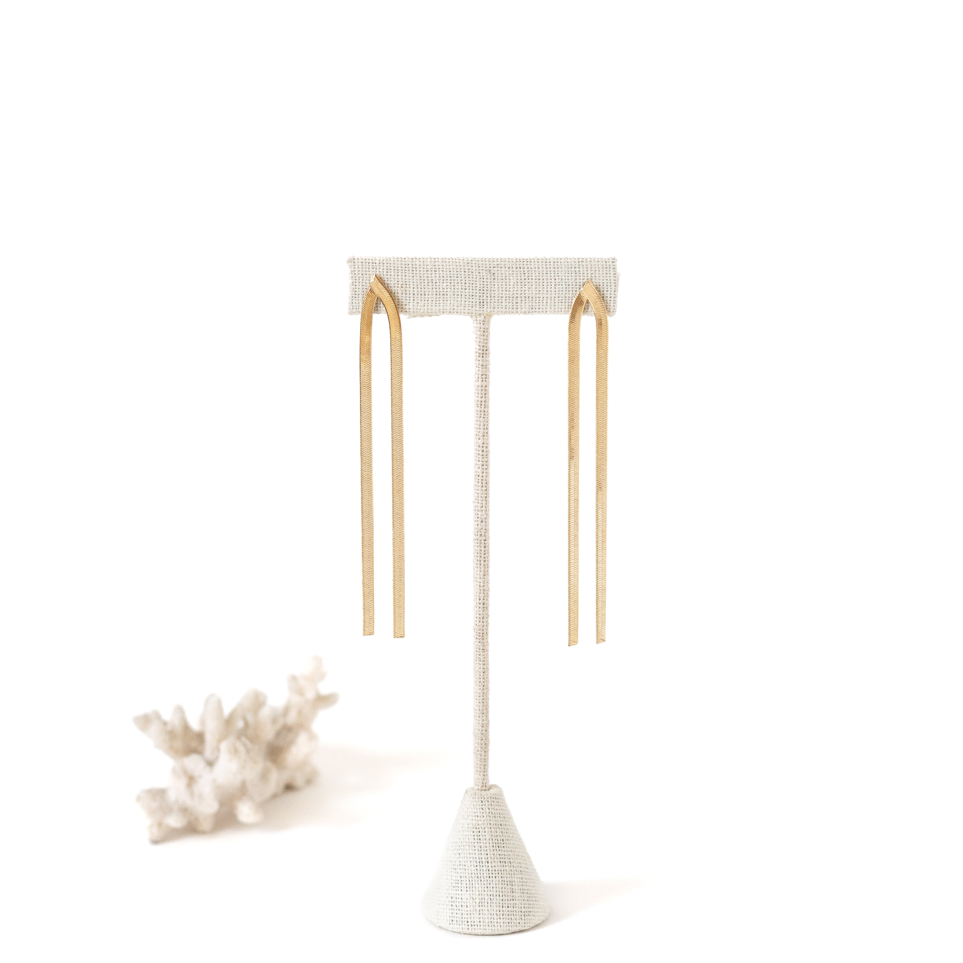 Gold plate post earrings with two gold strings hanging down.