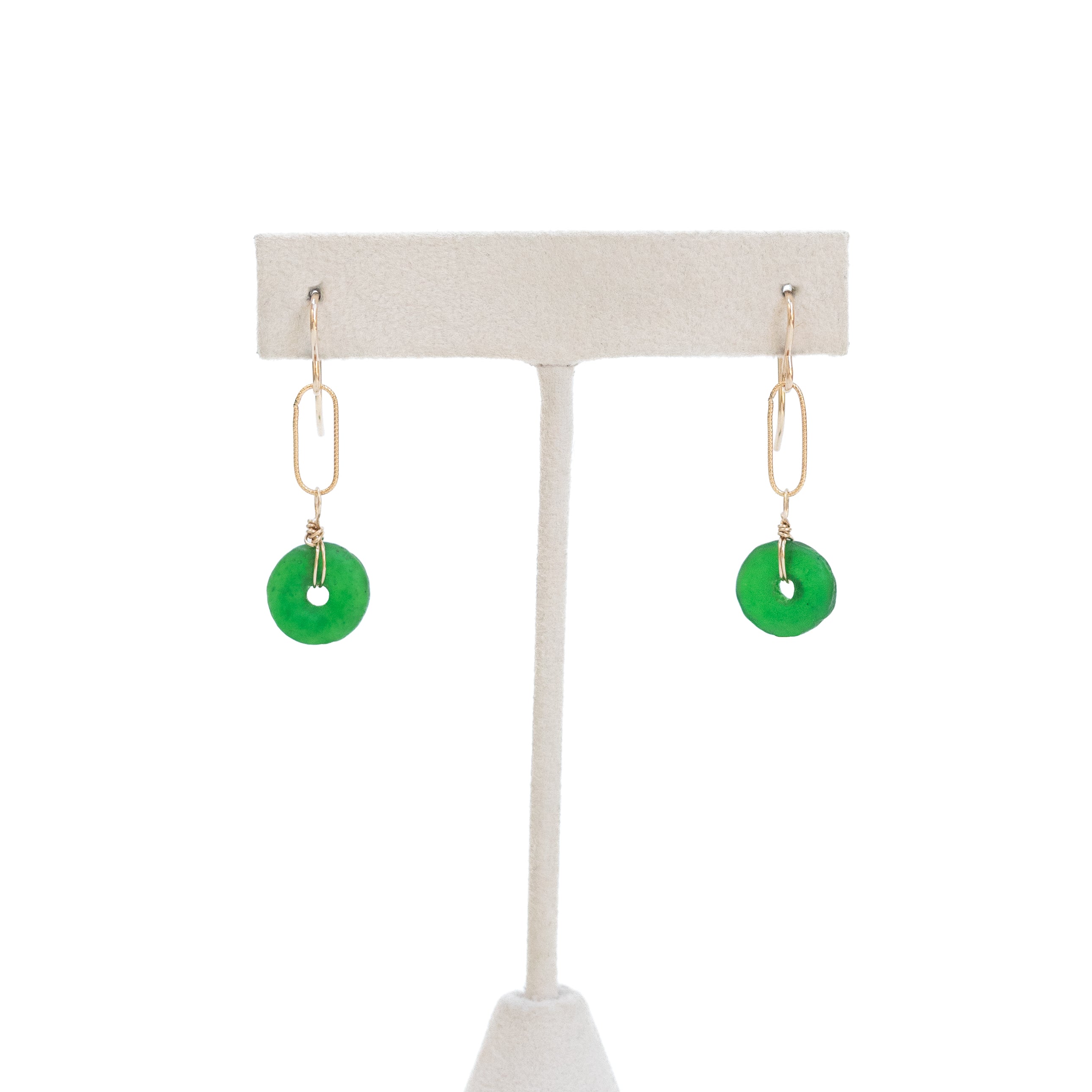 Green earrings on a white background