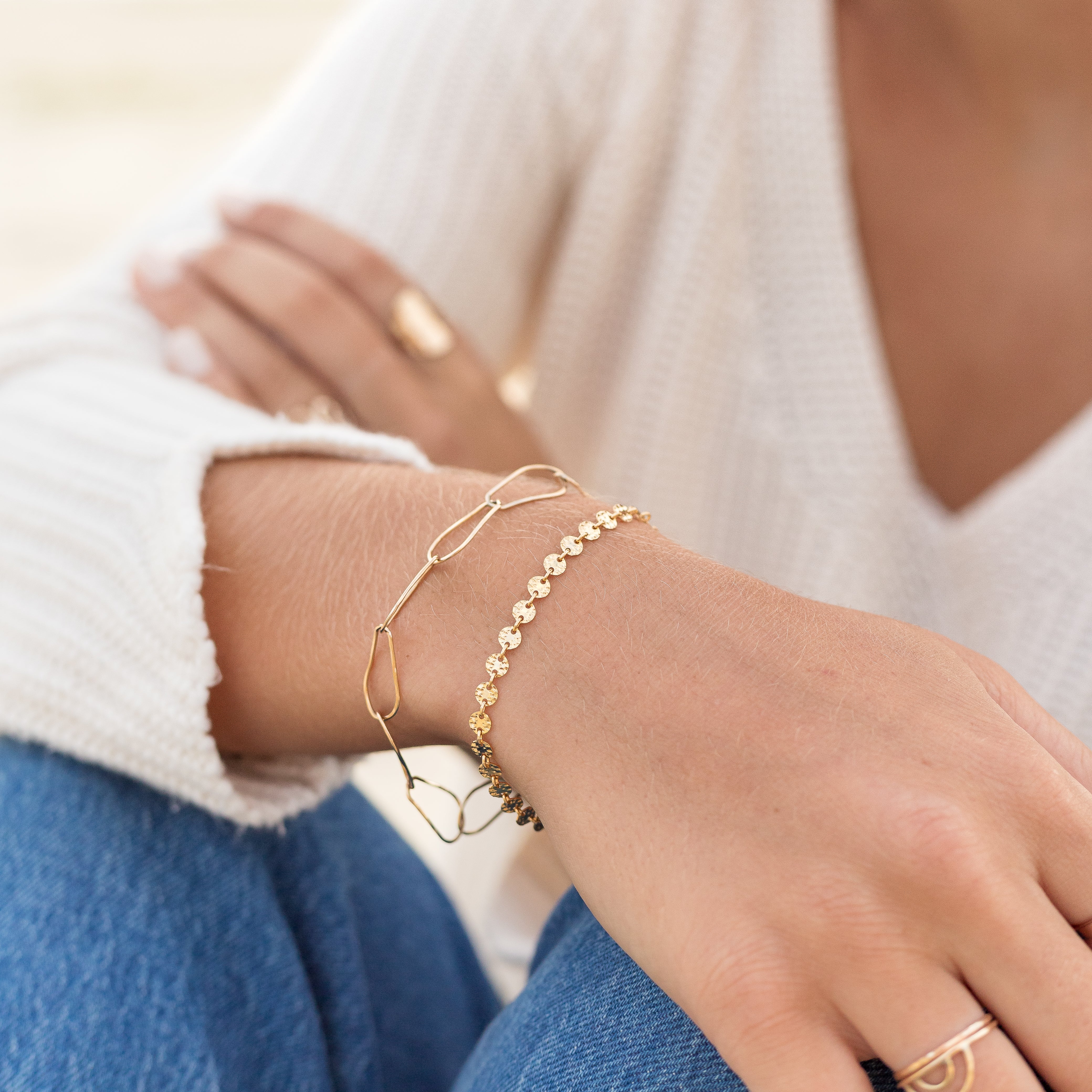 Dainty gold filled disk chain bracelet.  Shown with another gold bracelet on a woman's wrist.