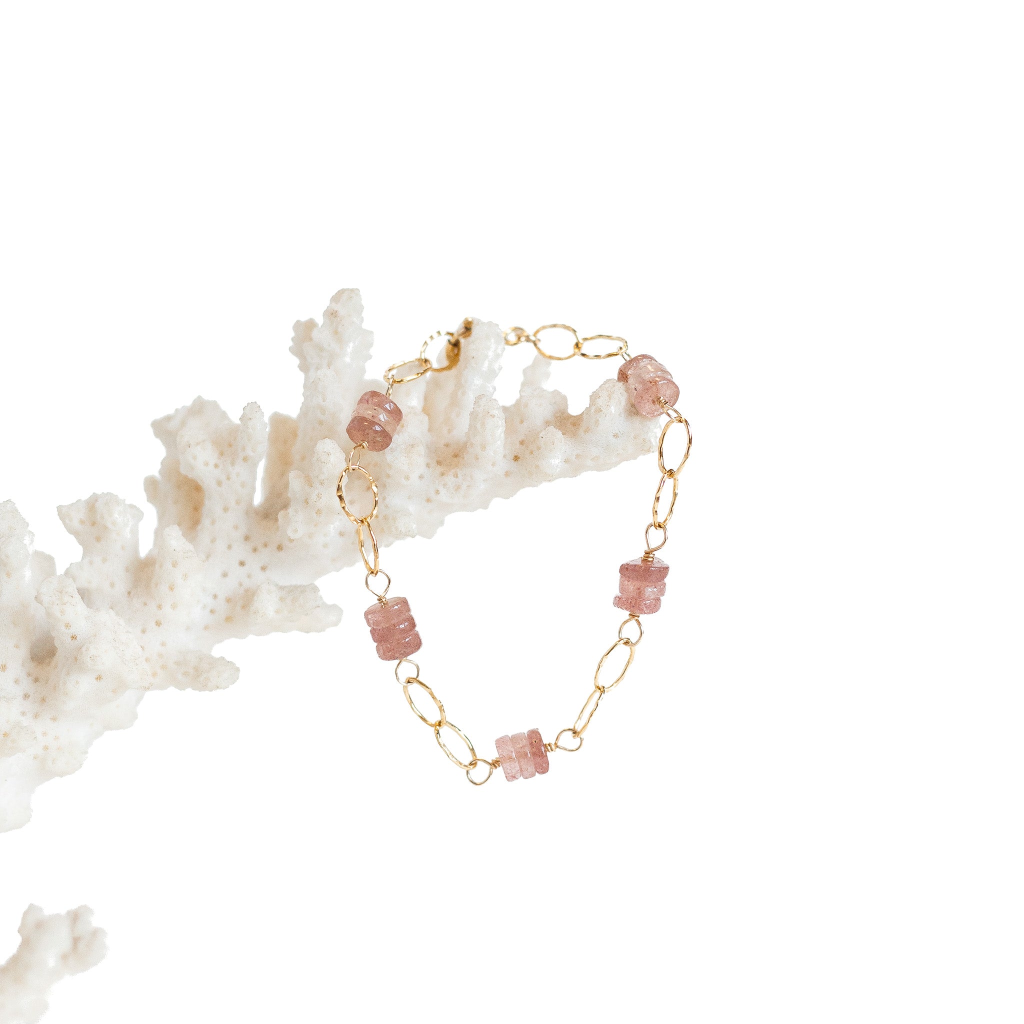 Gold chain and gold wire wrapped strawberry quartz bracelet. 