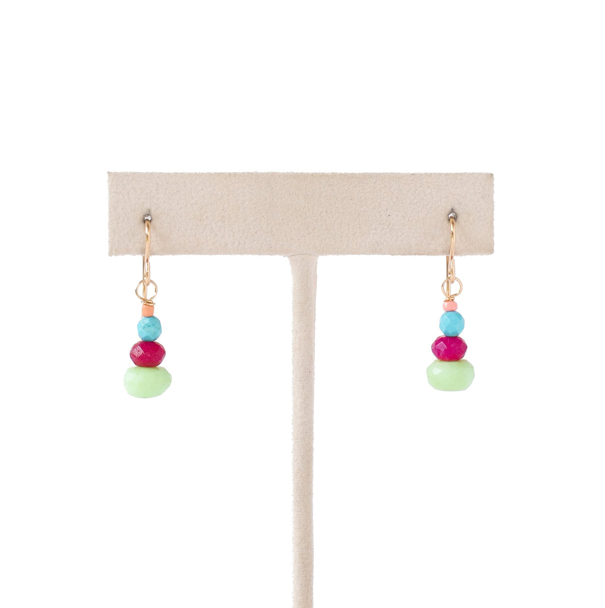 A pair of dangling earrings displayed on a beige jewelry stand against a white background. Each earring has small gold-tone hooks with stacked beads in turquoise blue, magenta pink, and light mint green.