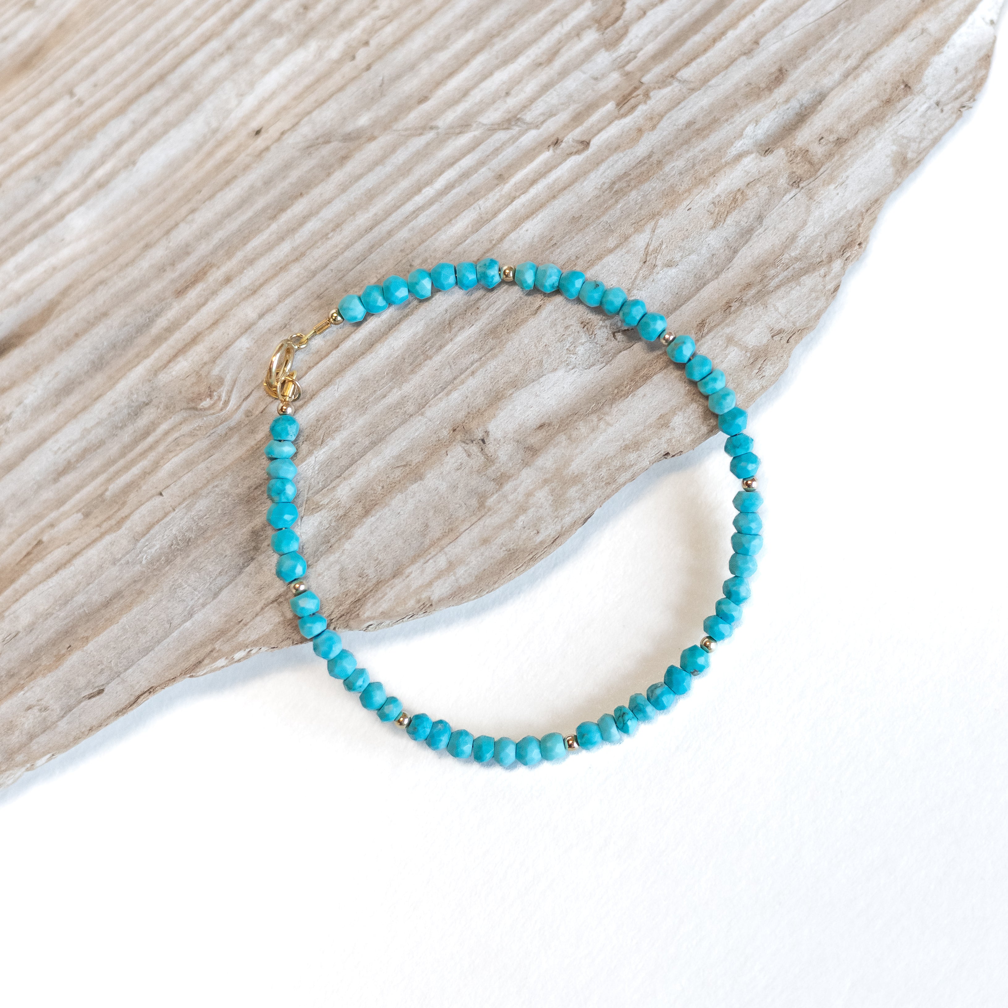 Turquoise beaded bracelet with gold filled beads every seven beads.