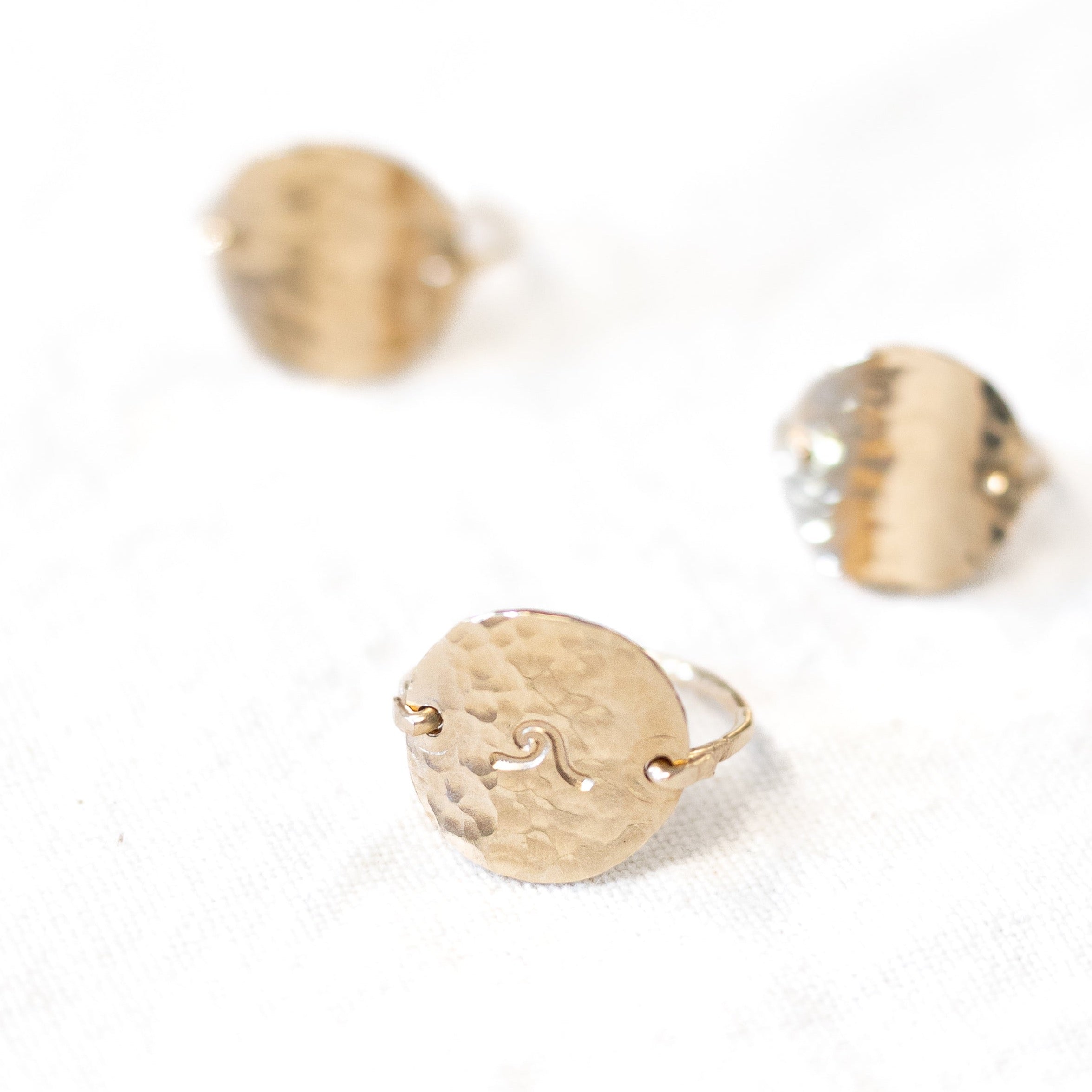 Nickel size gold filled circle hand forged into a ring with gold wire. Three shown in this image.