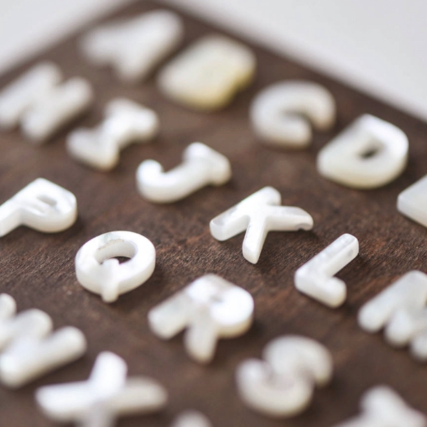 Mother of pearl initials shown.