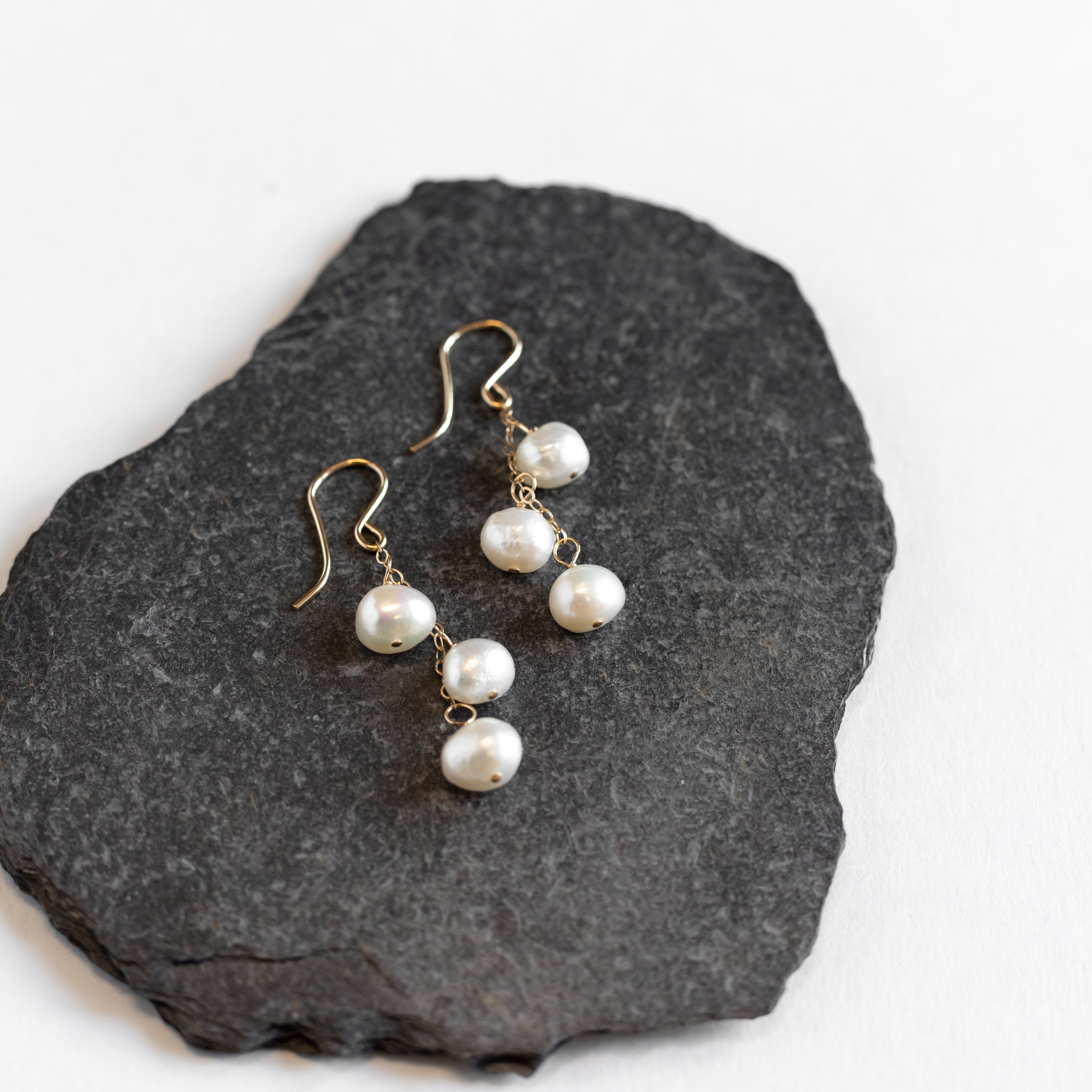 1.5 inch long earring with gold chain and pearls water-falling from the chain.