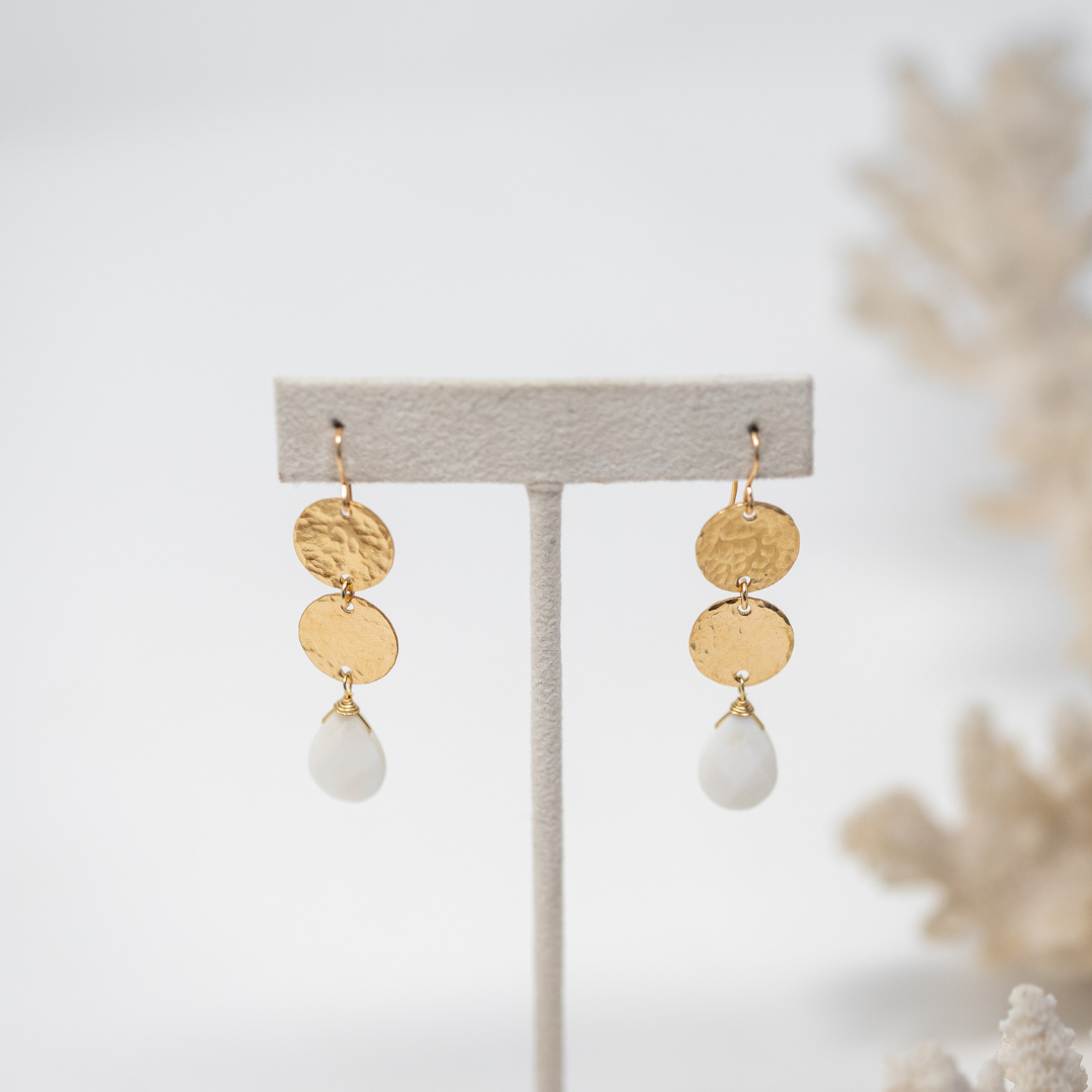 2 delicate and pretty gold hammered discs, with a faceted mother of pearl briolette hanging from the bottom. Gold filled hooks, overall length is 2 inches long.