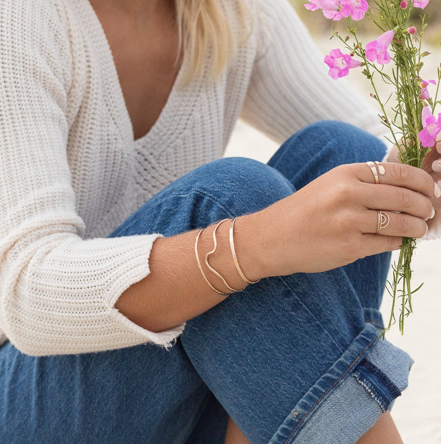 Organic gold filled cuff stack of three shown on a woman’s arm 