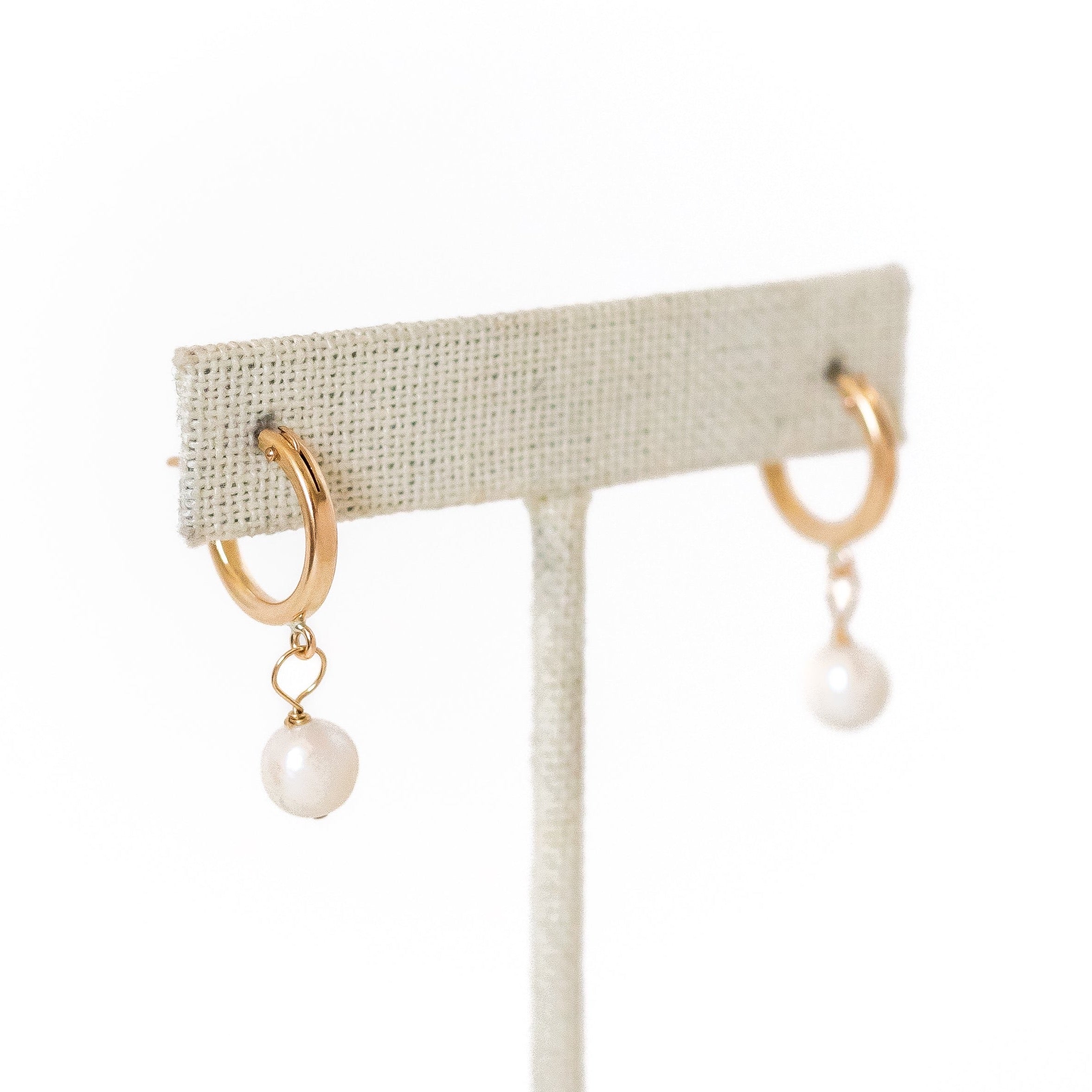 18 millimeter gold filled hoops with a tiny pearl wire wrapped to hang from the bottom. 