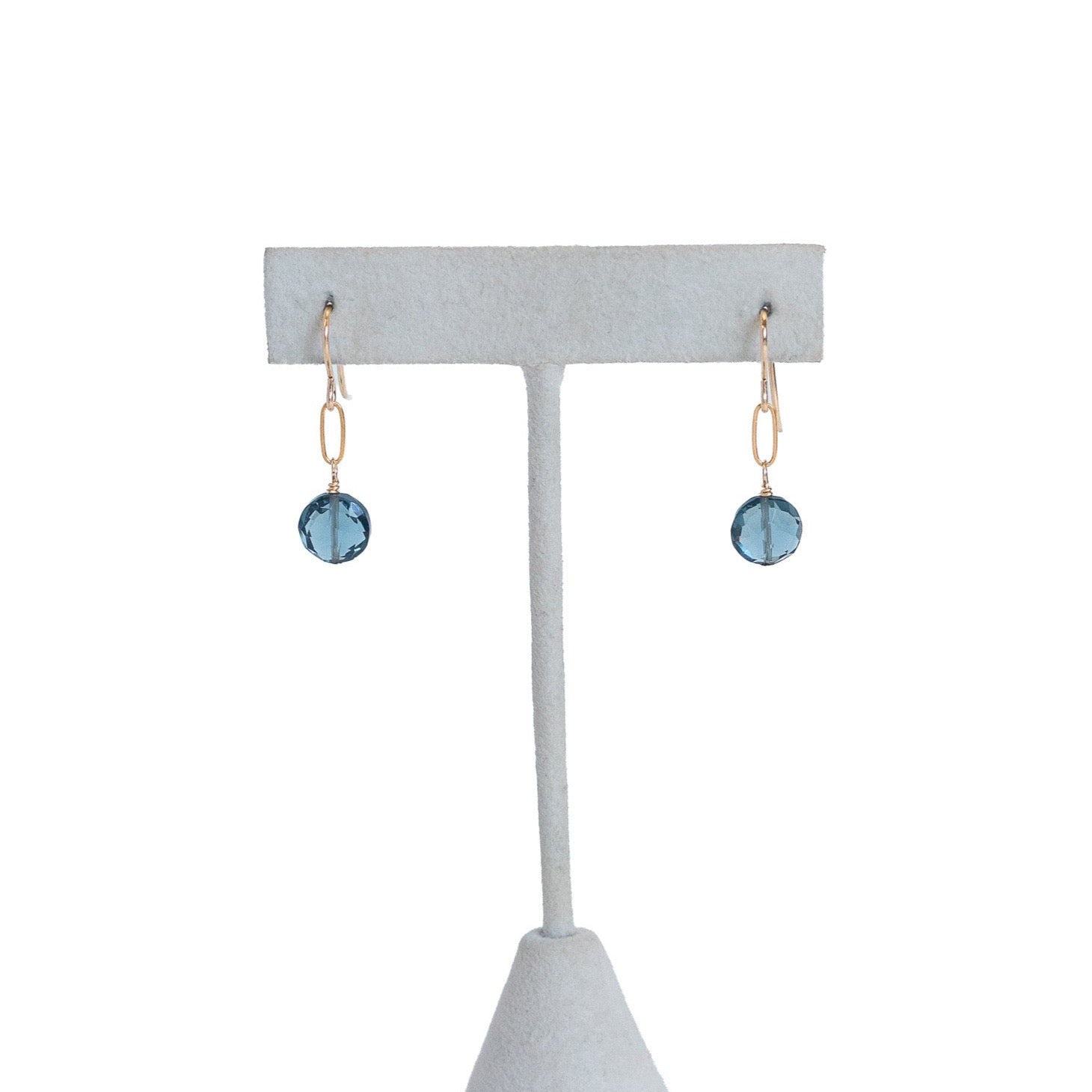 tiny dangle earrings with one gold filled paperclip chain link and one blue crystal on the bottom. 