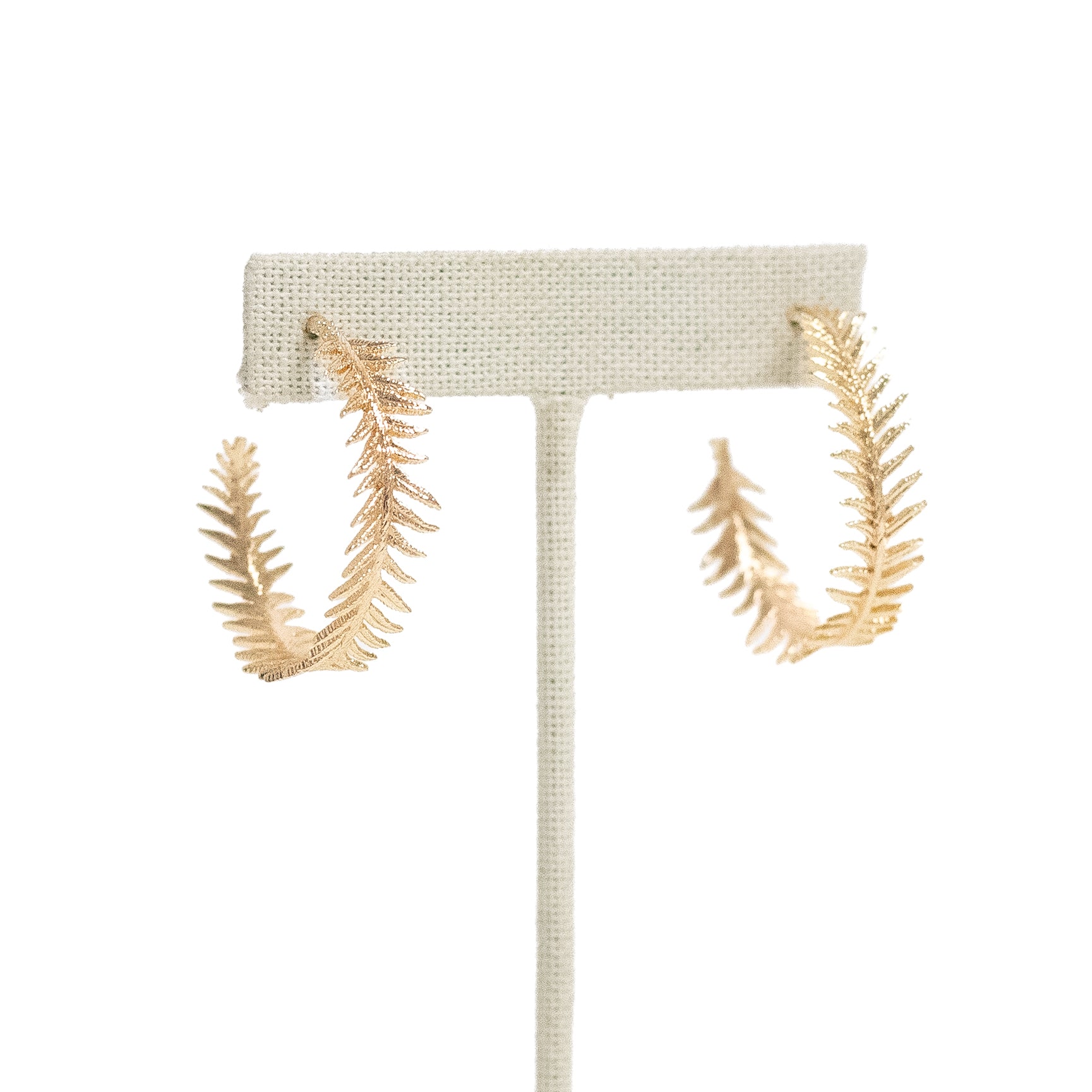 Gold plated feathered hoop earrings shown on an ear post.