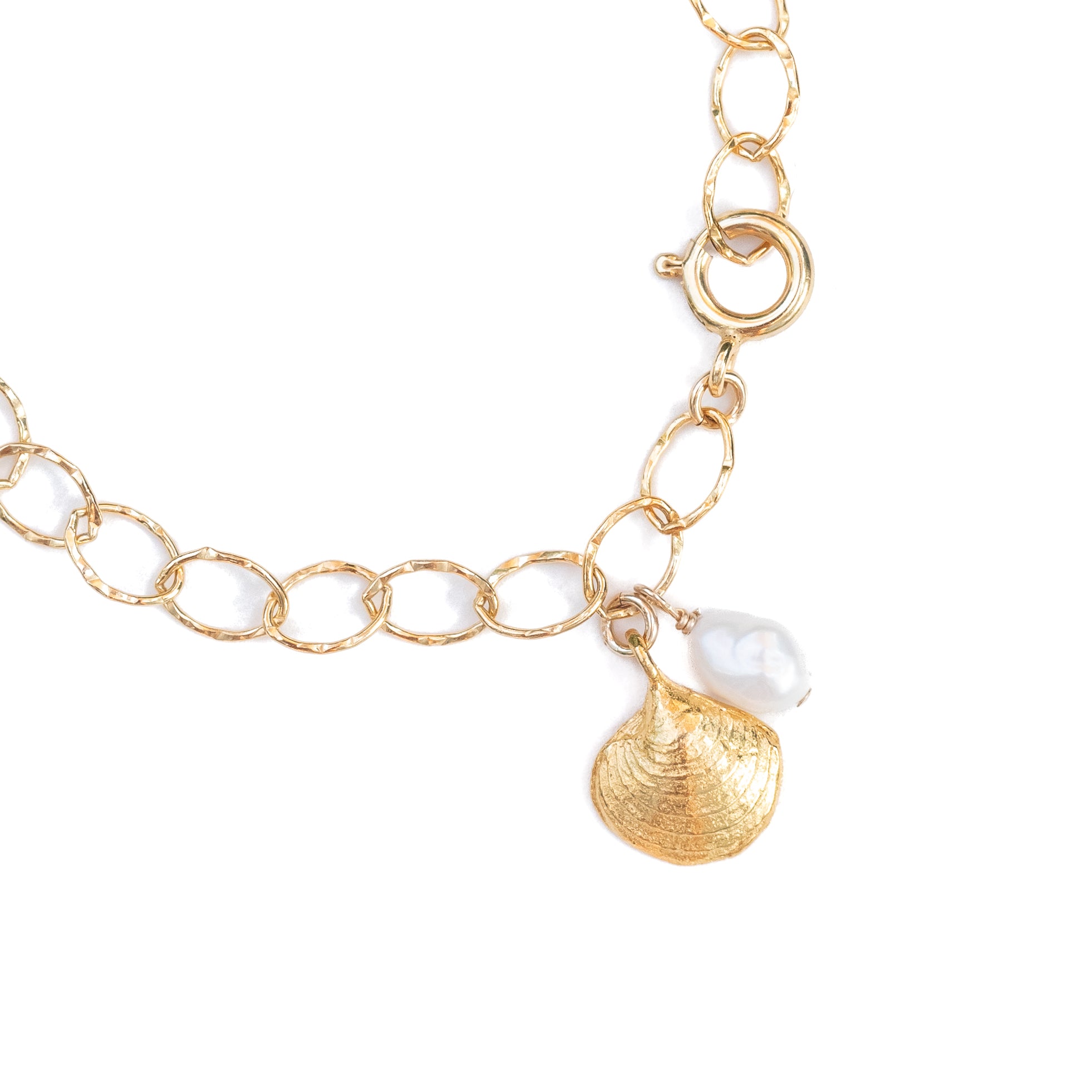Small clam shell charm and a freshwater pearl hanging from a textured 14k gold-filled chain. 