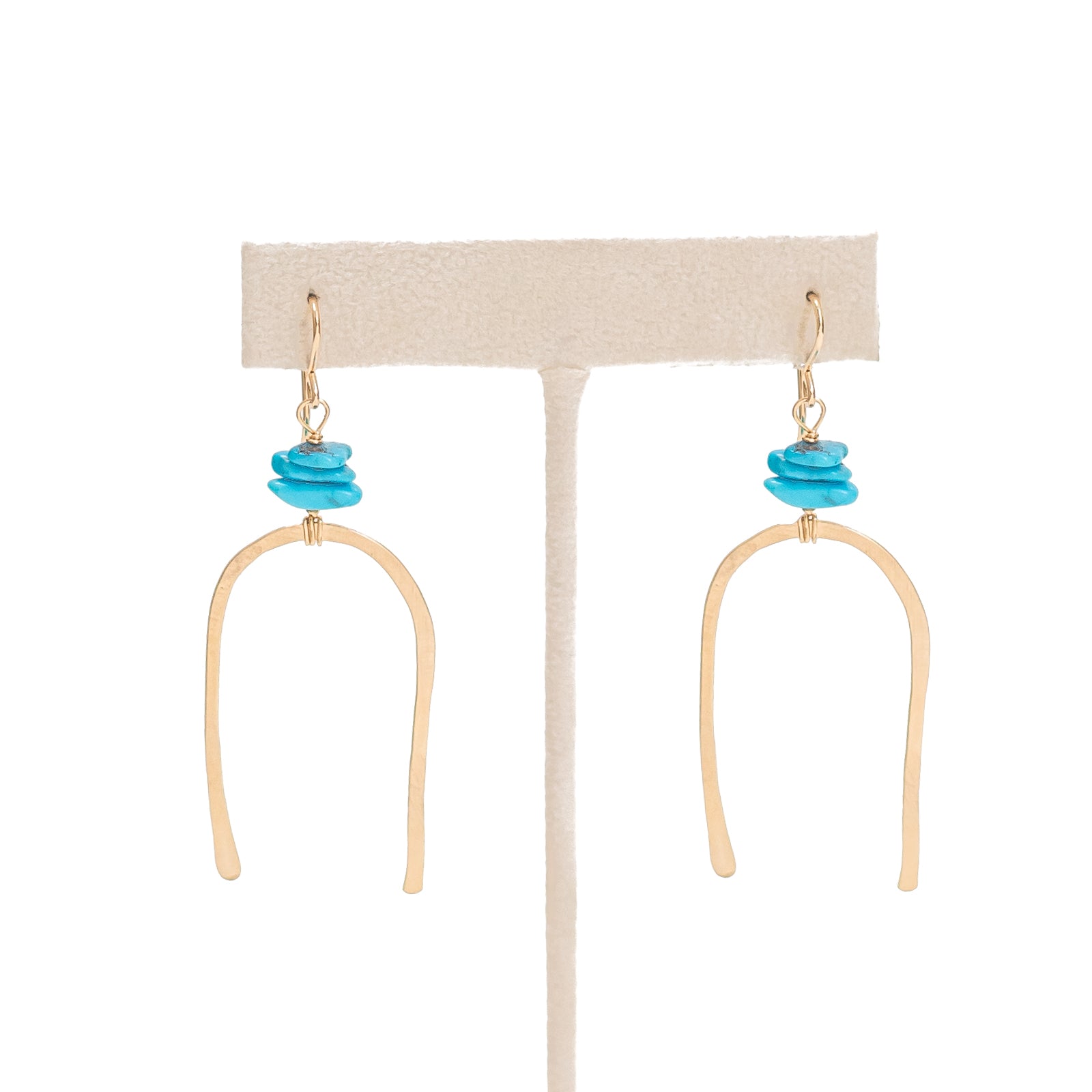 Gold filled large horseshoe with three turquoise beads wire wrapped above it. 