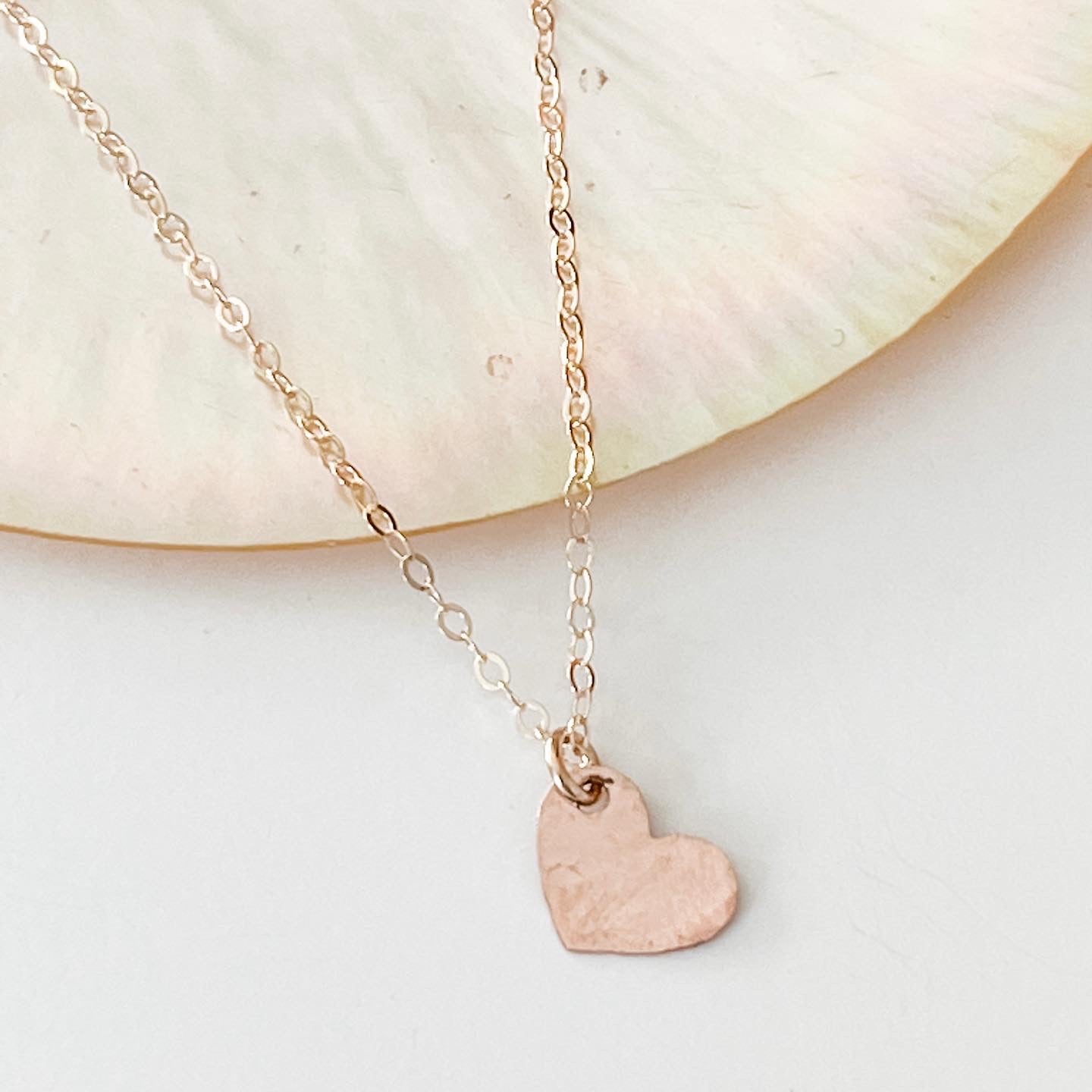 Rose gold hand cut heart on a gold chain. 