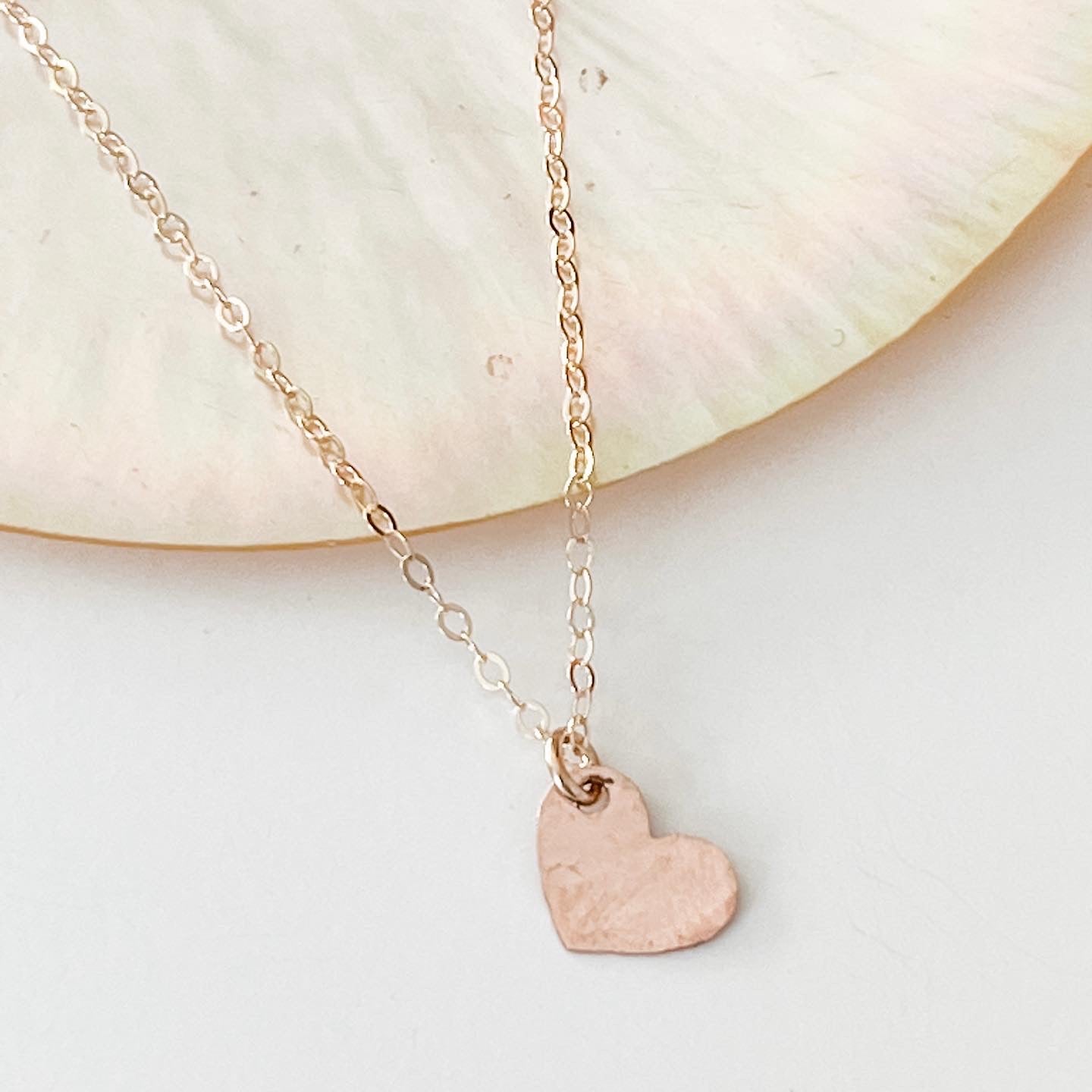 Tiny Rose gold heart on a gold chain. 