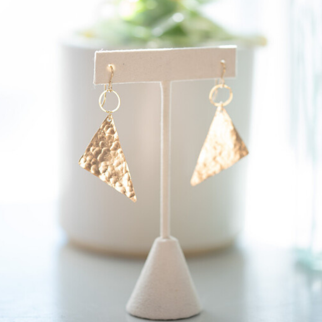 gold earrings with a small gold circle and gold hammered triangles dangling from the bottom. 