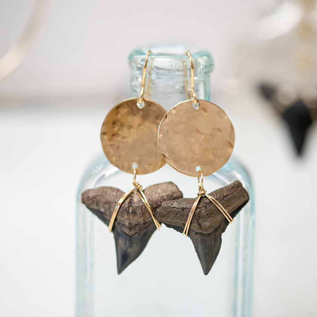 large gold filled circle with bull shark teeth attached to the bottom. 