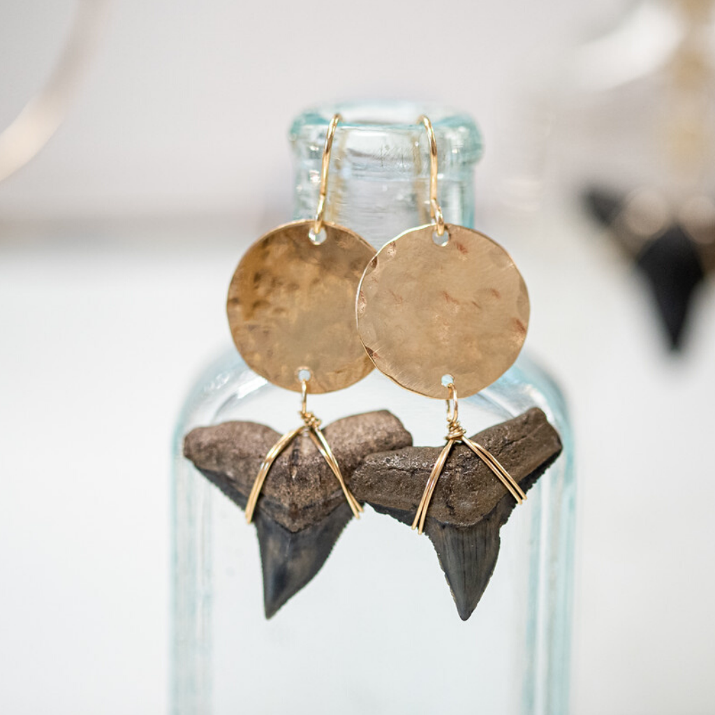 large gold filled circle with bull shark teeth attached to the bottom with gold wire. 