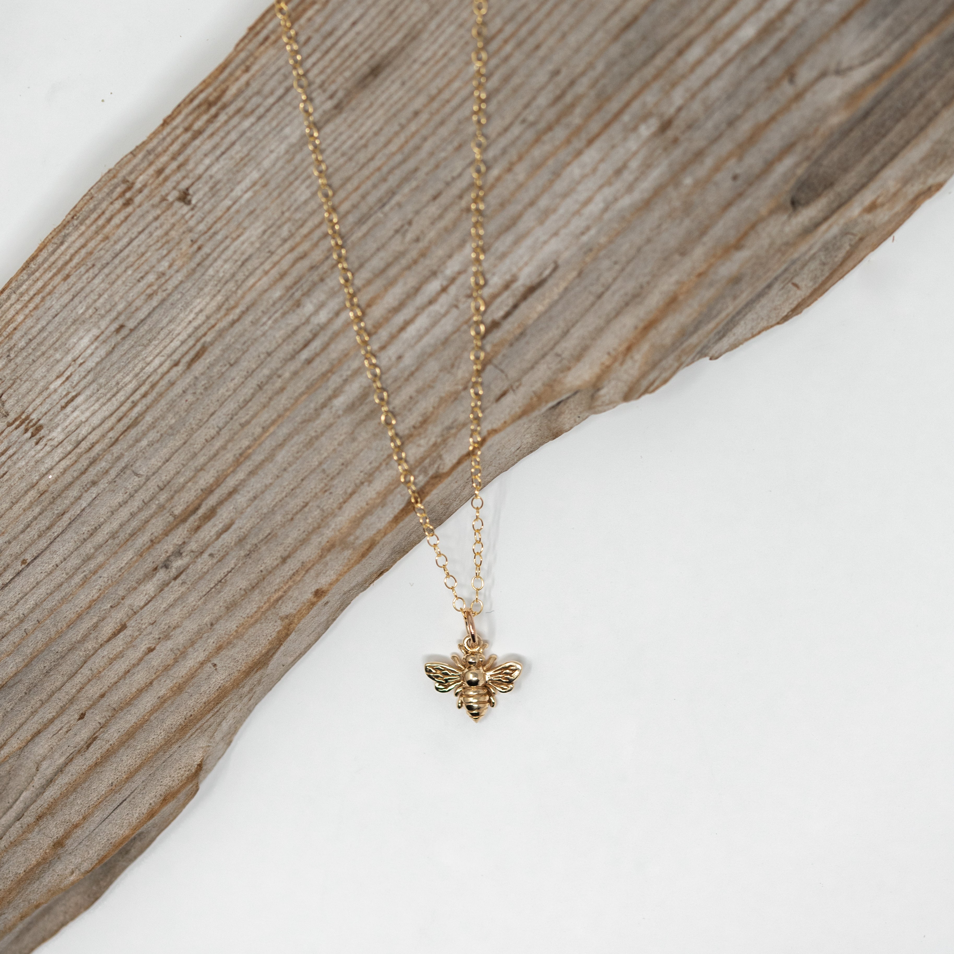 gold filled bee necklace on a gold chain.