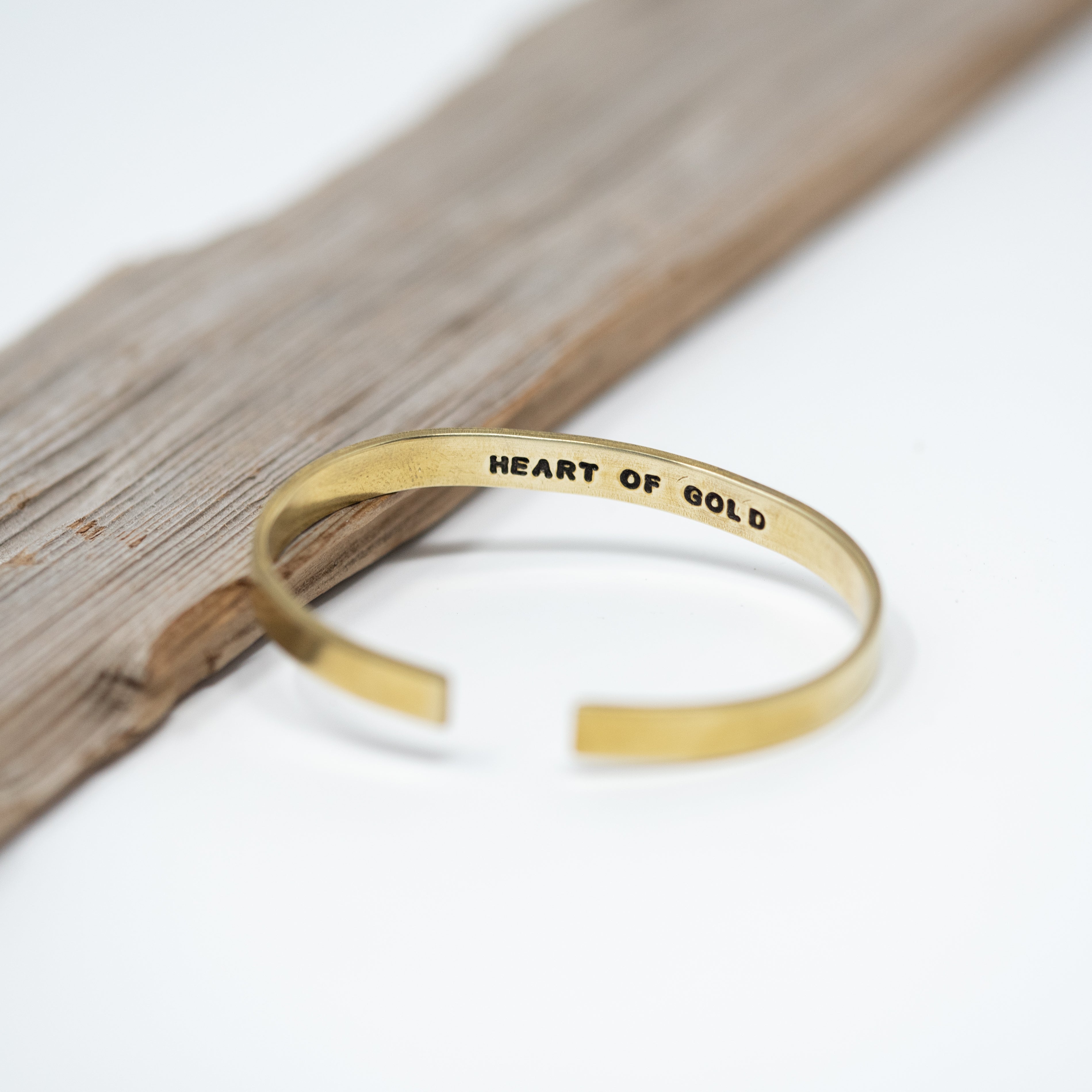 Brass cuff bracelet with phrases hand stamped on the inside of the bracelet  filled in with black coloring