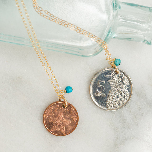 Two different coin necklaces with turquoise beads both attached to gold chains. 