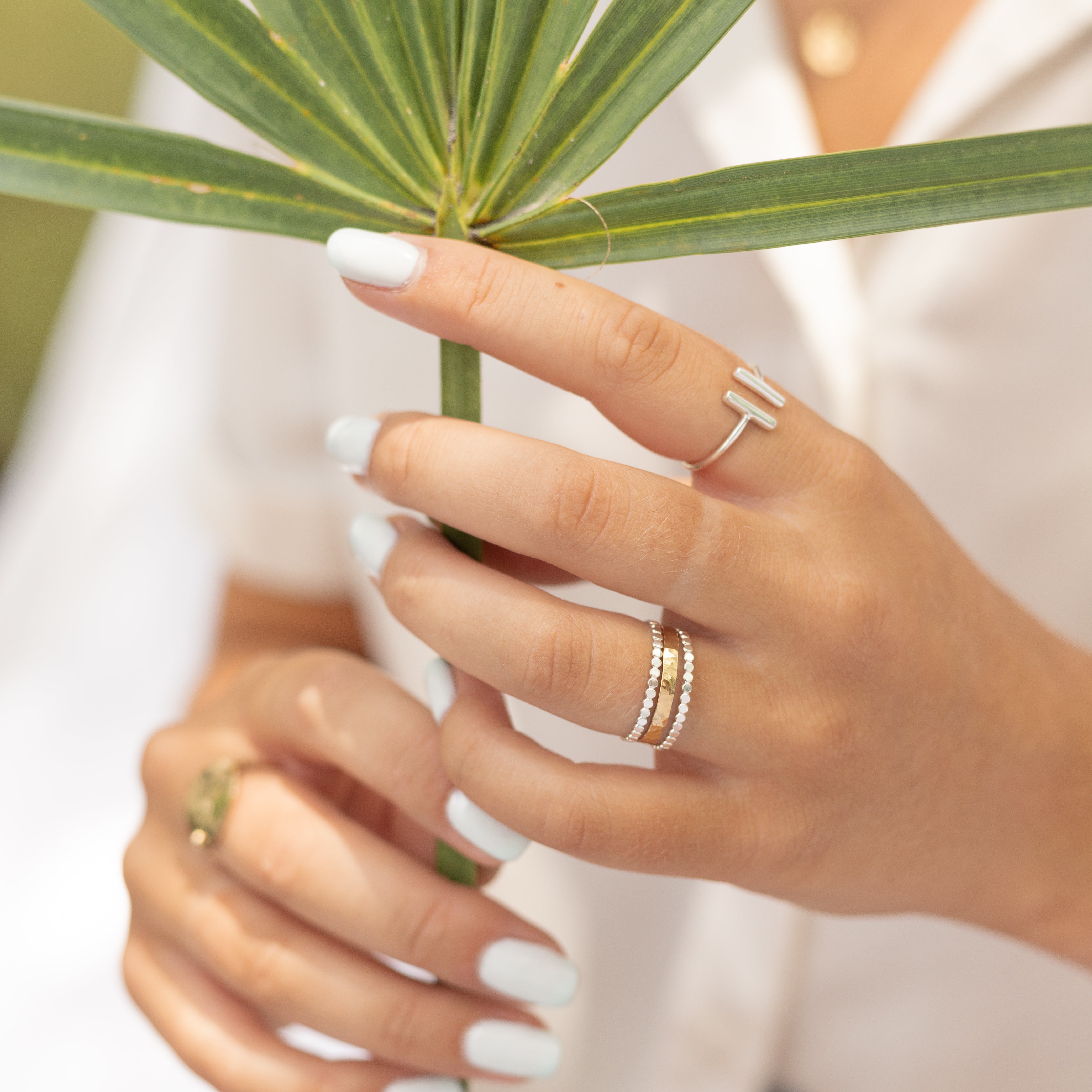 Sterling silver ring with dots going around it shown on a woman's finger