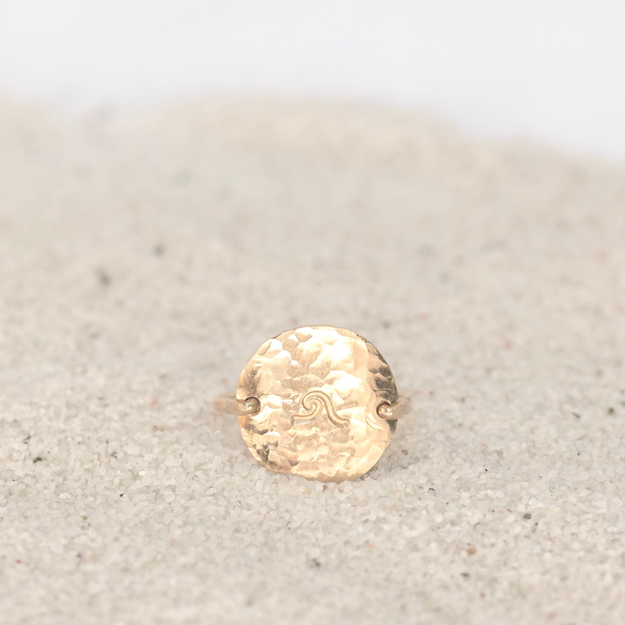 Nickel size gold filled circle hand forged into a ring with gold wire.