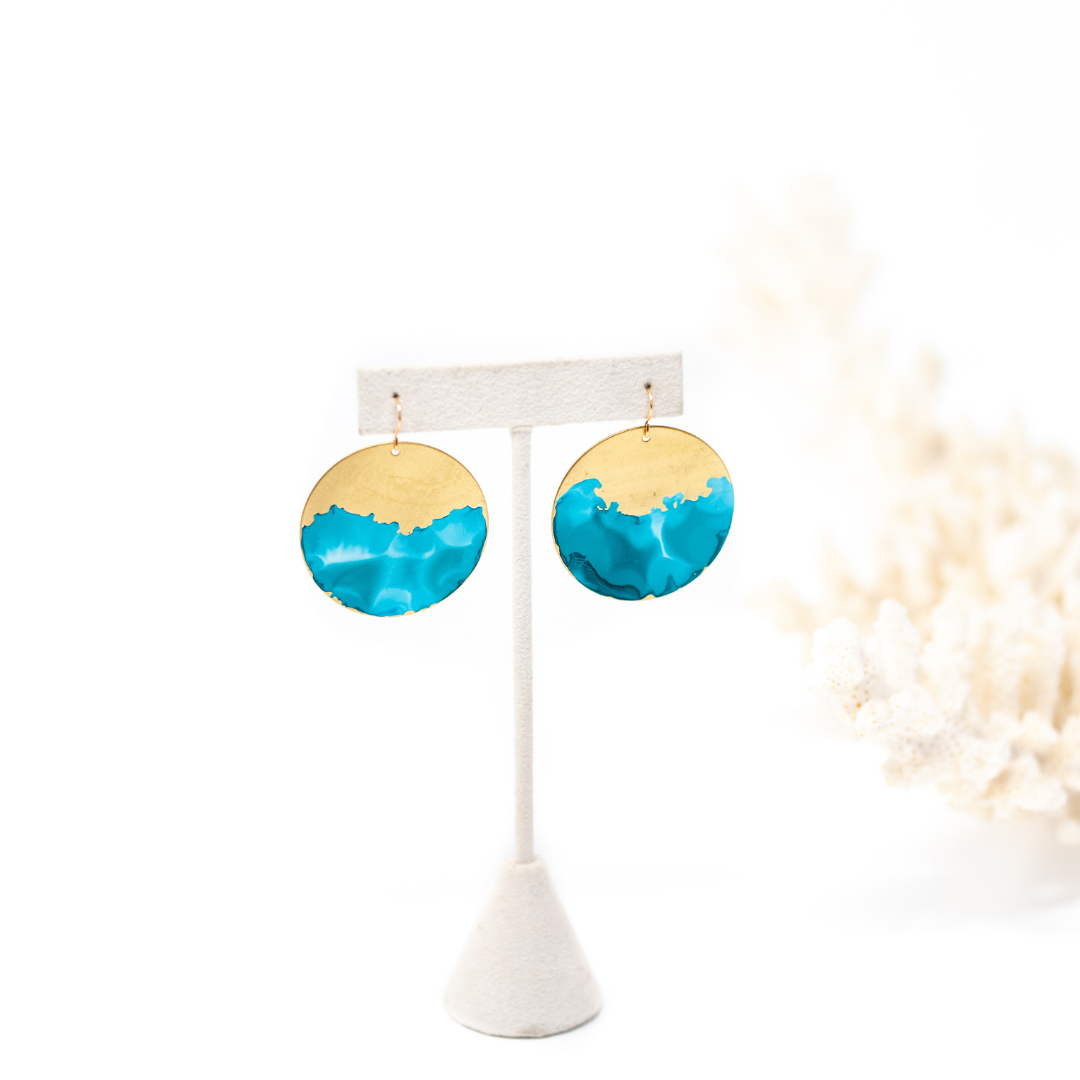 Brass circle earrings hand painted to have organic blue wave looking design on the bottom half. 